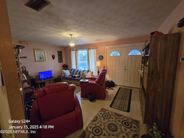 living room featuring carpet floors and a textured ceiling