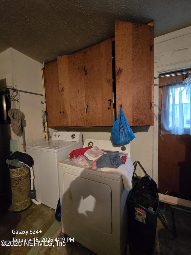 clothes washing area featuring wood walls, separate washer and dryer, and cabinets