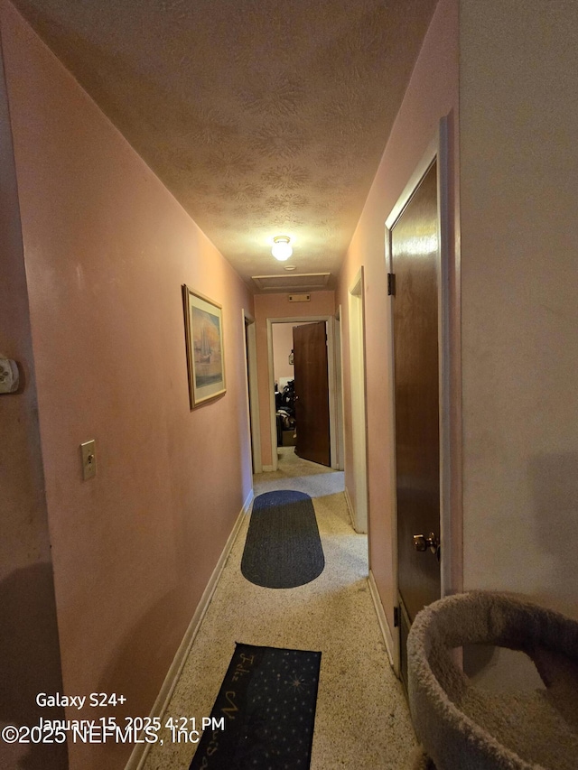 hallway featuring a textured ceiling