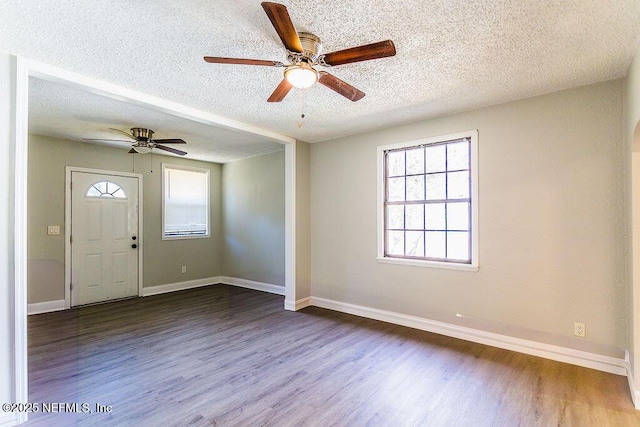 foyer featuring hardwood / wood-style flooring, ceiling fan, and a textured ceiling