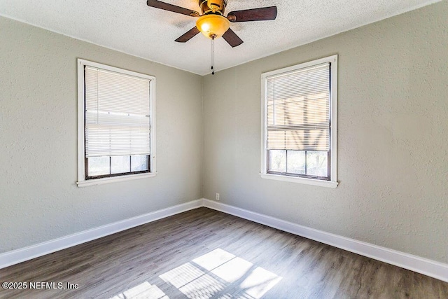 spare room featuring ceiling fan, hardwood / wood-style flooring, and a textured ceiling