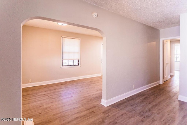 spare room with hardwood / wood-style flooring and a textured ceiling