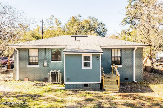 rear view of house featuring cooling unit