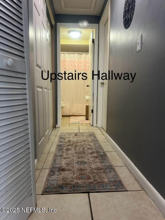 hallway with light tile patterned floors