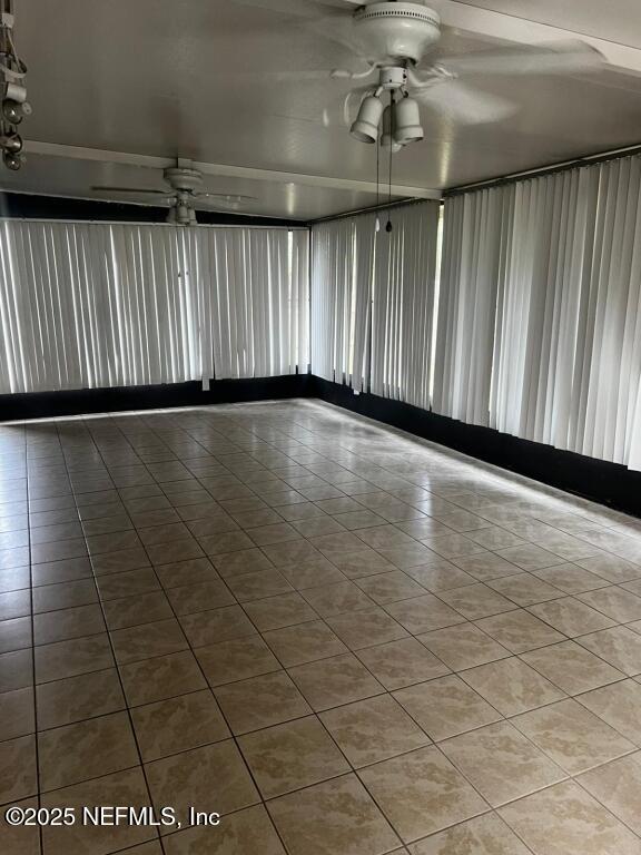 unfurnished room featuring ceiling fan and tile patterned floors