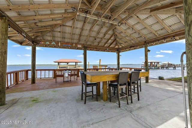 view of patio featuring a gazebo, a water view, and an outdoor bar