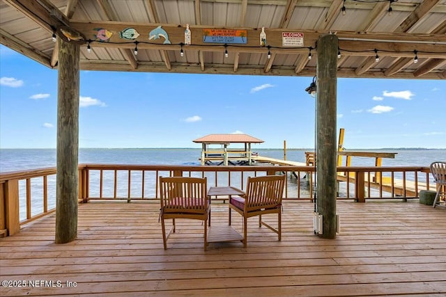 view of dock featuring a water view, a beach view, and a gazebo