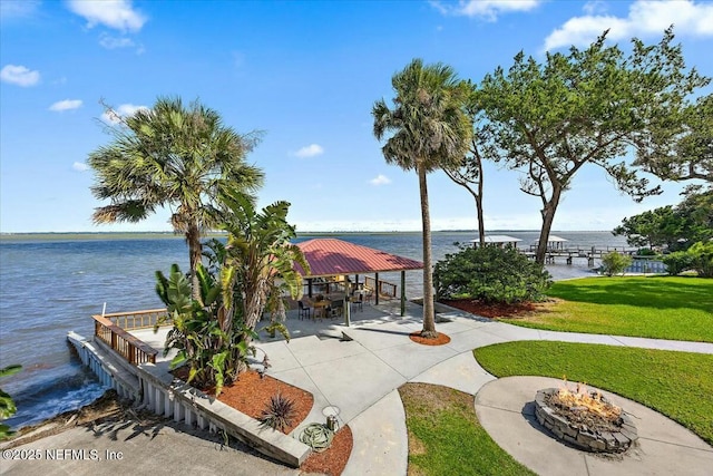 view of home's community featuring a fire pit, a yard, a gazebo, and a water view