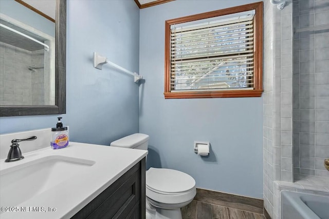 full bathroom with tiled shower / bath, vanity, toilet, and ornamental molding