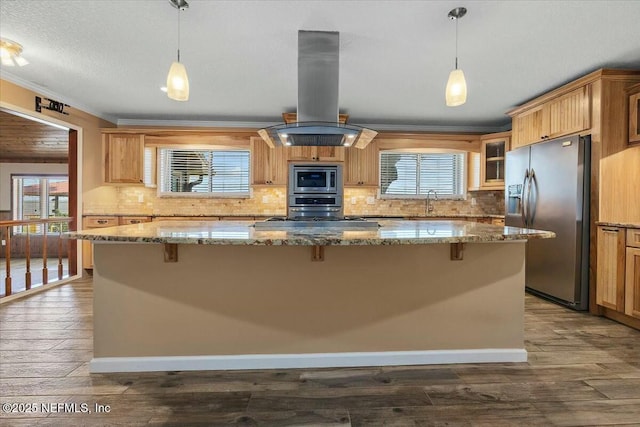 kitchen with crown molding, a breakfast bar area, stainless steel appliances, and island exhaust hood