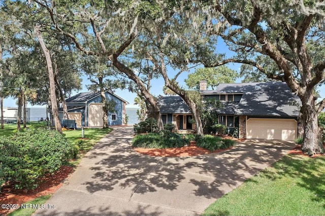 view of front of house featuring a garage and a front lawn