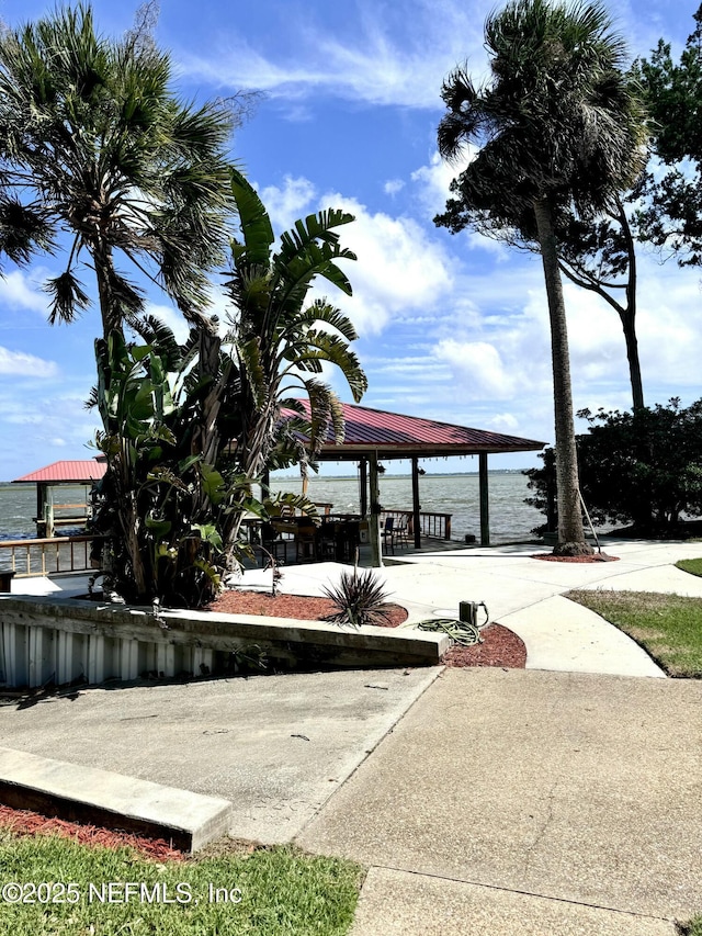 view of property's community with a gazebo and a water view