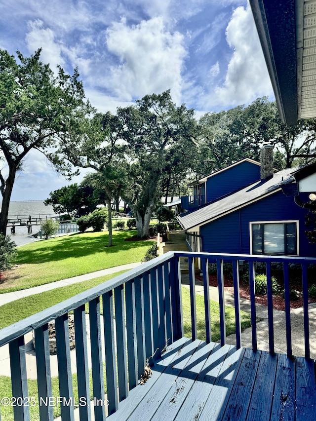 wooden deck featuring a yard and a water view