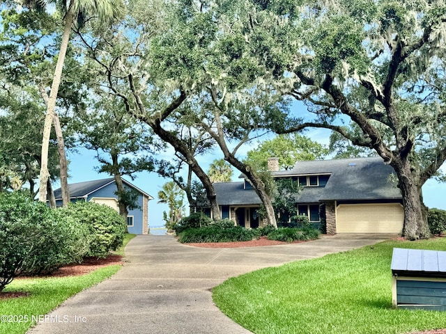 view of front facade with a garage and a front lawn