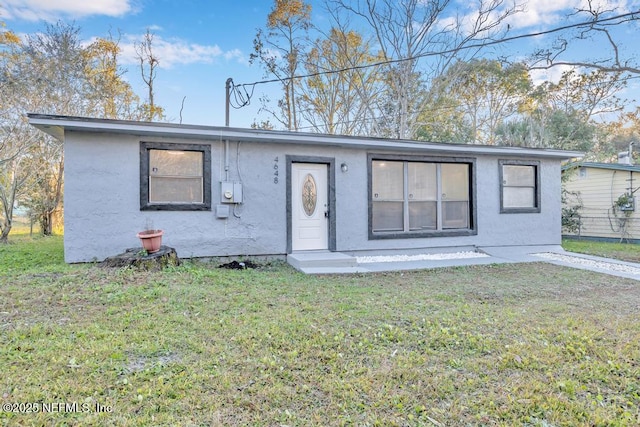 ranch-style home with a front lawn