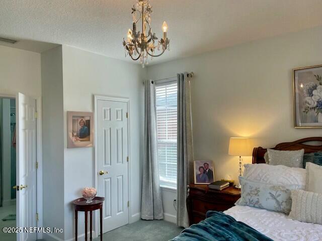 bedroom with carpet and a chandelier