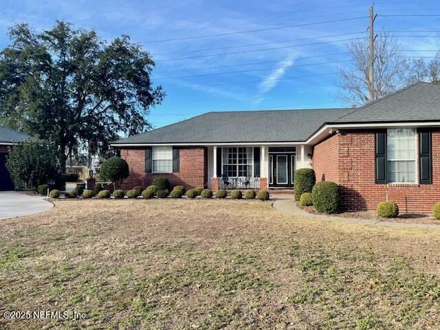 ranch-style house featuring a front yard and a porch