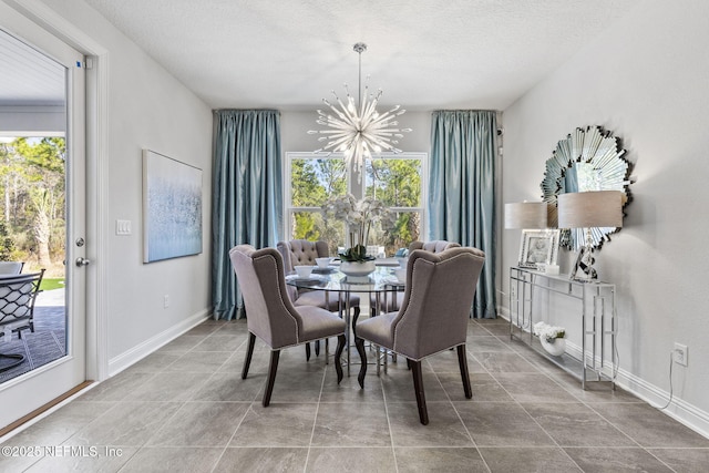 dining area featuring a chandelier, a textured ceiling, and a wealth of natural light