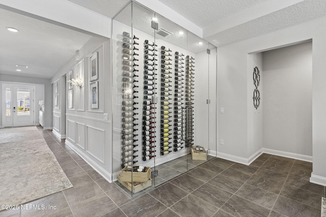 wine cellar featuring a textured ceiling