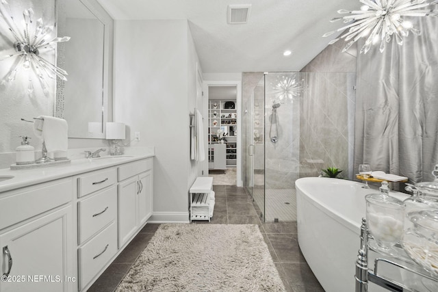 bathroom with vanity and separate shower and tub