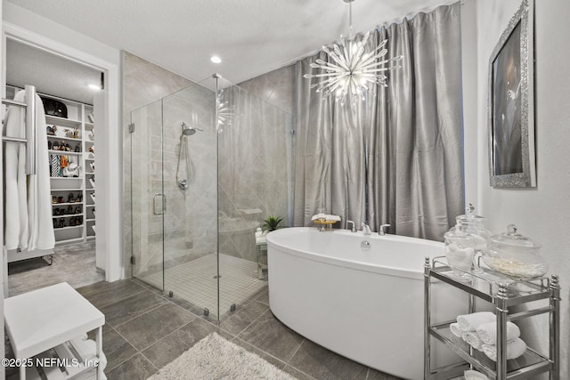 bathroom featuring shower with separate bathtub and a textured ceiling