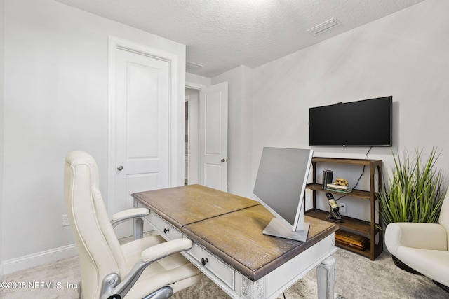 office area with light carpet and a textured ceiling