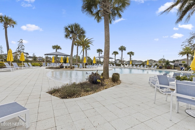 view of pool with a gazebo, a water view, and a patio area