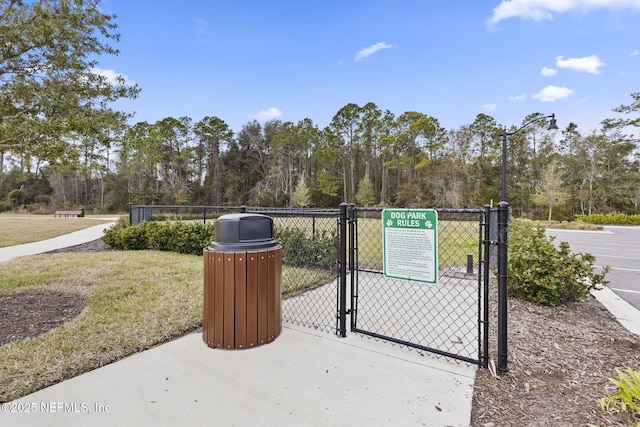 view of gate with a lawn