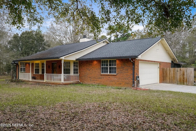 ranch-style house featuring a front yard, covered porch, and a garage