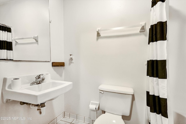 bathroom featuring sink, tile patterned floors, and toilet