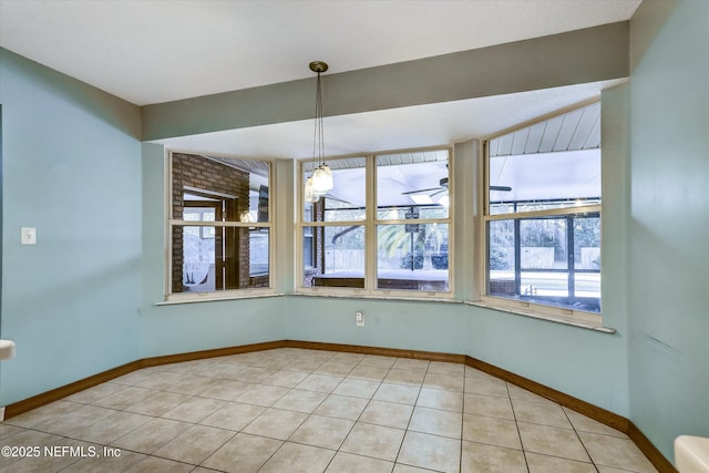 unfurnished dining area with light tile patterned flooring