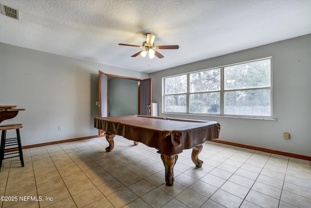 game room with ceiling fan, billiards, light tile patterned flooring, and a textured ceiling