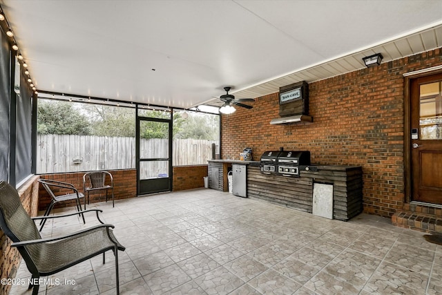 sunroom / solarium featuring ceiling fan