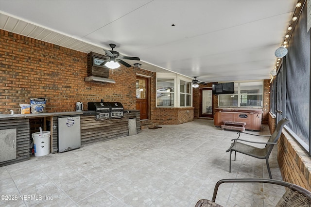 view of patio / terrace featuring ceiling fan, a grill, area for grilling, and a hot tub