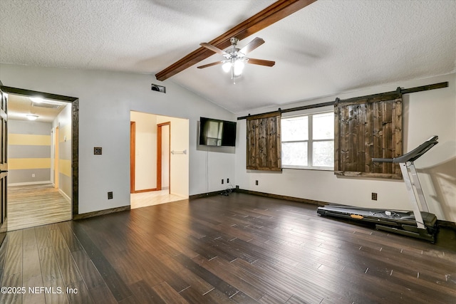 workout area featuring ceiling fan, a textured ceiling, dark hardwood / wood-style floors, and vaulted ceiling