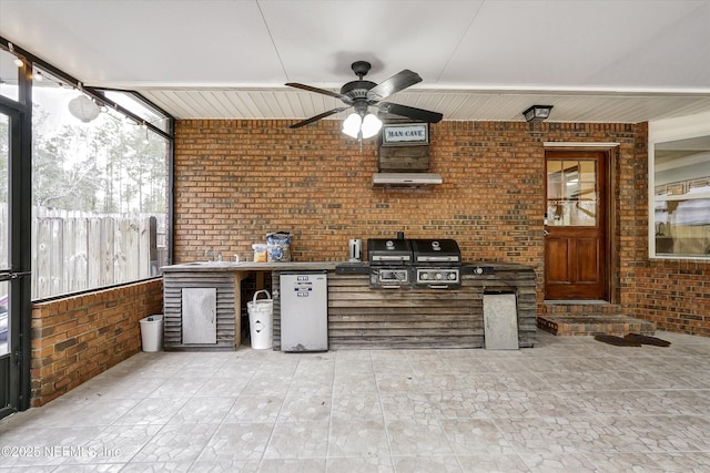 view of patio featuring ceiling fan, area for grilling, exterior kitchen, and sink