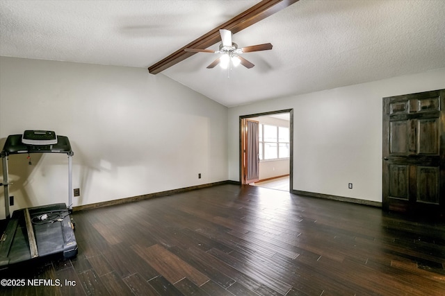 exercise area featuring ceiling fan, vaulted ceiling, dark hardwood / wood-style flooring, and a textured ceiling