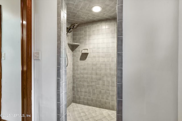 bathroom with a tile shower