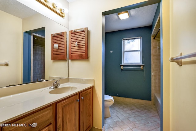 bathroom with toilet, tile patterned flooring, a textured ceiling, and vanity