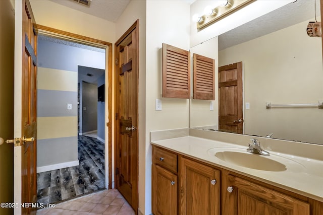 bathroom with vanity and a textured ceiling