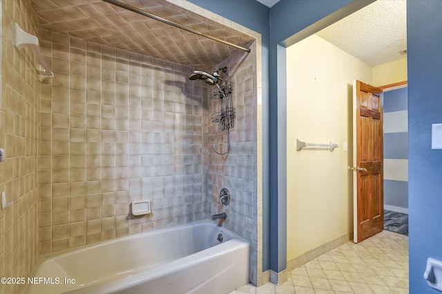 bathroom featuring a textured ceiling and tiled shower / bath combo