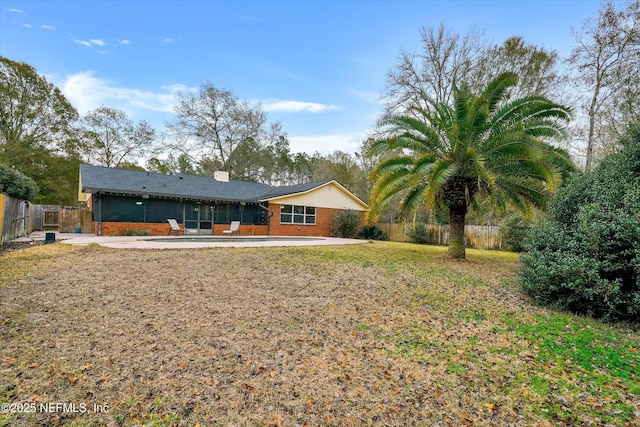 back of property featuring a patio area and a lawn