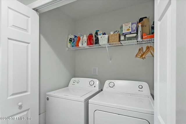 laundry area with washing machine and clothes dryer