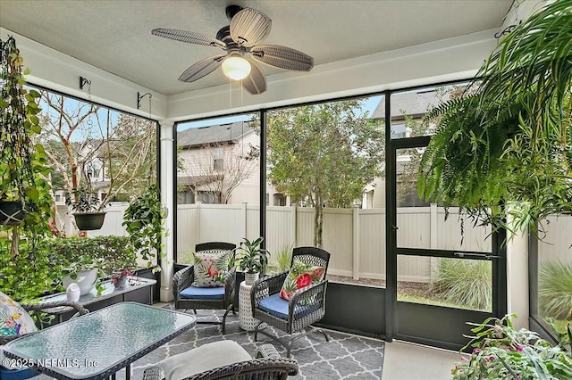 sunroom / solarium featuring ceiling fan and plenty of natural light