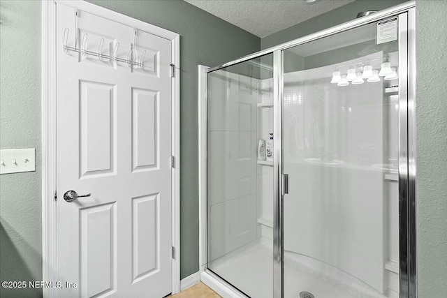 bathroom featuring a textured ceiling and walk in shower