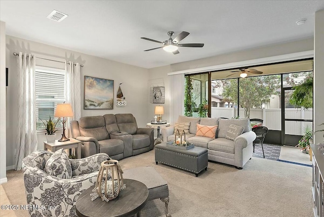 carpeted living room with ceiling fan