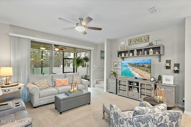 carpeted living room featuring ceiling fan