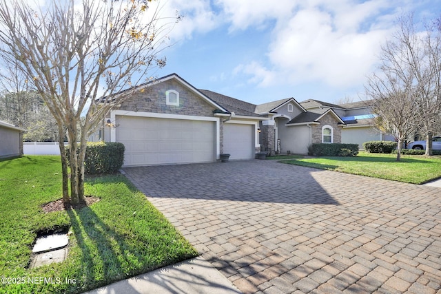 ranch-style home featuring a front yard and a garage