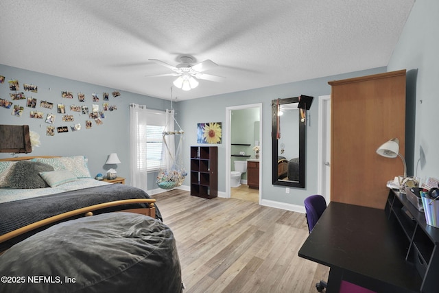 bedroom featuring ceiling fan, light hardwood / wood-style floors, connected bathroom, and a textured ceiling