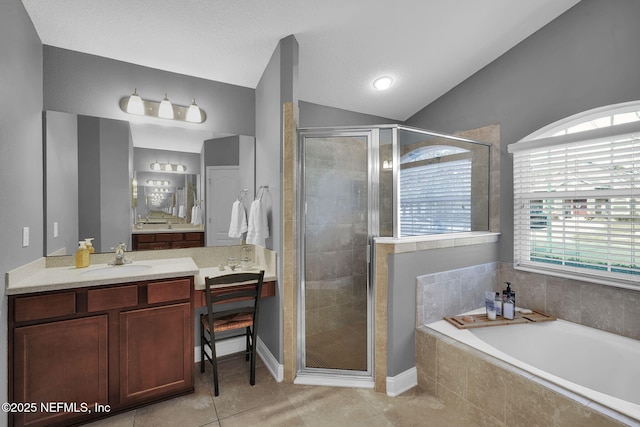 bathroom with vanity, lofted ceiling, independent shower and bath, and tile patterned flooring